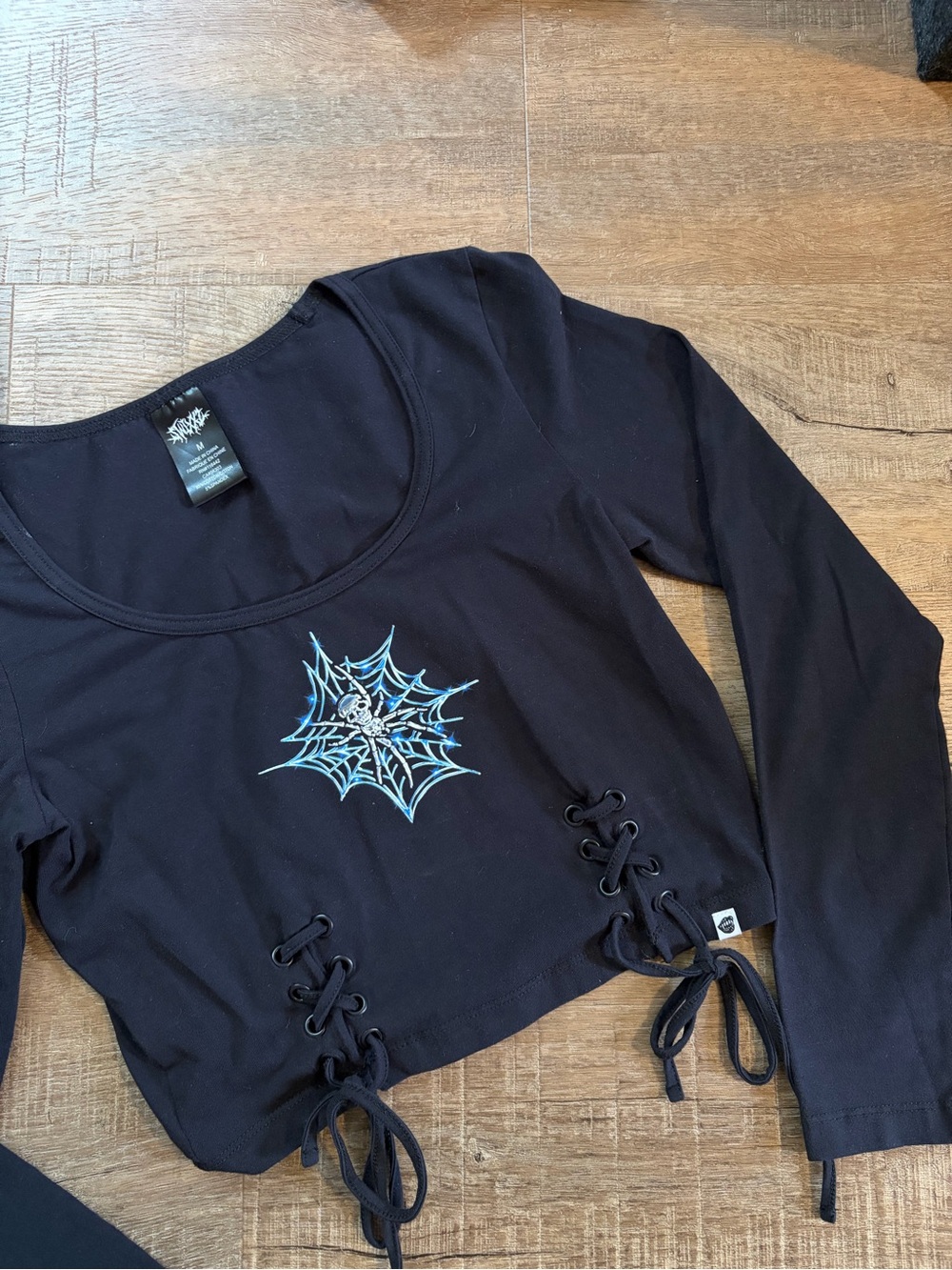 Zumiez Black Long-Sleeve Lace-Up Crop Top with Blue Web Graphic